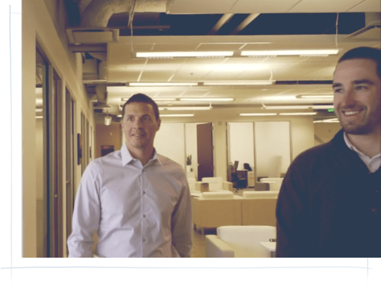 two business men walking in an office building